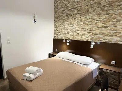 a bedroom with a bed with towels on it at Eleni Rooms in Rhodes Town