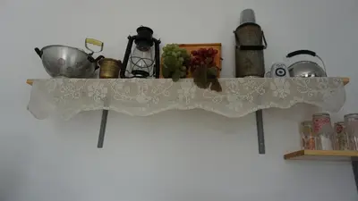 a white lace curtain on a shelf with a sink at Greek stories by evaGstays in Faliraki