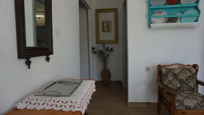 a room with a bed and a mirror and a chair at Greek stories by evaGstays in Faliraki