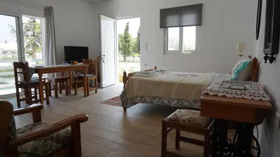 a bedroom with a bed and a table and chairs at Greek stories by evaGstays in Faliraki