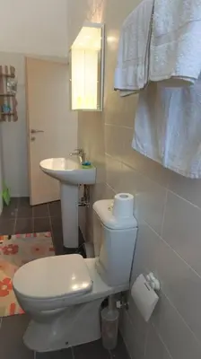 a bathroom with a toilet and a sink at Greek stories by evaGstays in Faliraki