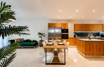 a kitchen and living room with a table and a couch at CASA DI RODINI in Rhodes Town