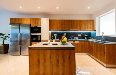 a large kitchen with wooden cabinets and a counter top at CASA DI RODINI in Rhodes Town