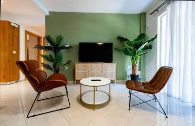 a living room with two chairs and a tv at CASA DI RODINI in Rhodes Town