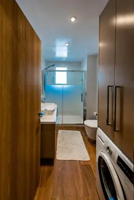 a bathroom with a toilet and a sink and a washing machine at CASA DI RODINI in Rhodes Town