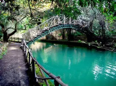 a blue bridge over a river with a fence at CASA DI RODINI in Rhodes Town