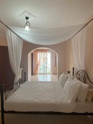 a bedroom with a white bed with a window at Kasteli Cozy House in Archangelos