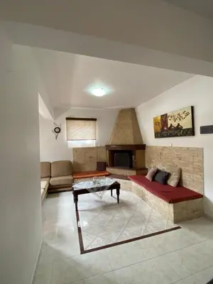 a living room with a couch and a fireplace at Kasteli Cozy House in Archangelos
