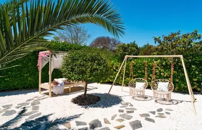 a playground with two chairs and a swing at Villa Iasama in Rhodes Town
