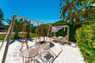 a swing with a baby in a mirror at Villa Iasama in Rhodes Town