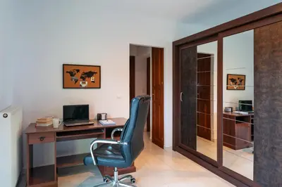 an office with a desk and a blue chair at Villa Iasama in Rhodes Town