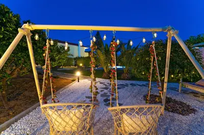 a swing in a park at night at Villa Iasama in Rhodes Town