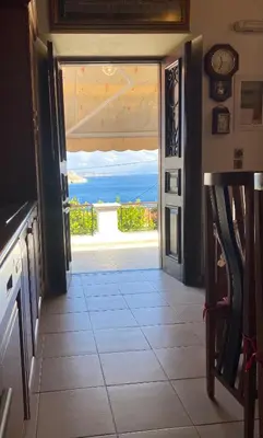 an open door to a room with a view of the ocean at Traditional Villa Christos & Tholos In Chalki in Halki