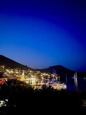 a harbor at night with boats in the water at Traditional Villa Christos & Tholos In Chalki in Halki