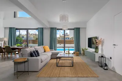 a living room with a couch and a table at Villa Incerto in Ialyssos
