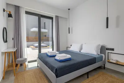 a bedroom with a bed with two towels on it at Villa Incerto in Ialyssos