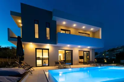 a house with a swimming pool in front of it at Villa Incerto in Ialyssos