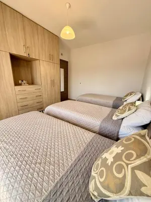 a bedroom with two beds and a dresser at Odysseia Stay Pool & Private Jacuzzi 2min Beach in Kremasti