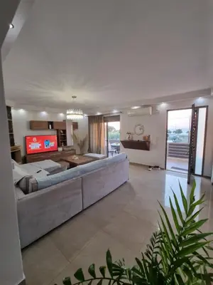 a large living room with a couch and a tv at Odysseia Stay Pool & Private Jacuzzi 2min Beach in Kremasti