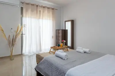a bedroom with a bed with two pillows on it at Odysseia Stay Pool & Private Jacuzzi 2min Beach in Kremasti