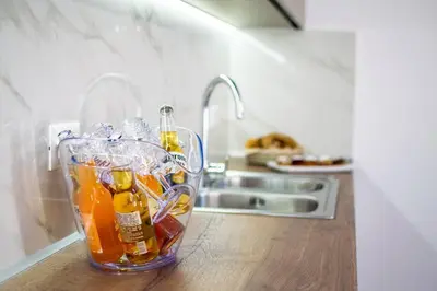 a glass container filled with bottles on top of a kitchen counter at Fileo Family and Friends Living in Archangelos