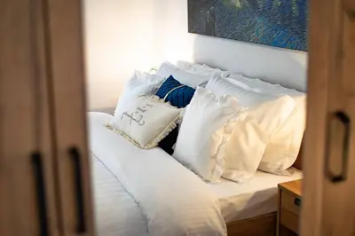 a white bed with pillows on top of it at Fileo Family and Friends Living in Archangelos