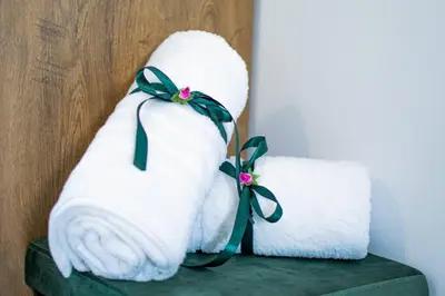 two towels with green bows sitting on a green stool at Fileo Family and Friends Living in Archangelos