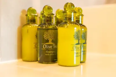a group of olive oil bottles sitting on a counter at City Compass Luxury Villa in Faliraki