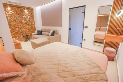 a bedroom with a bed and a living room at City Compass Luxury Villa in Faliraki