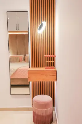a room with a mirror and a stool and a bed at City Compass Luxury Villa in Faliraki