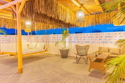 a pavilion with a bed and a table and chairs at City Compass Luxury Villa in Faliraki