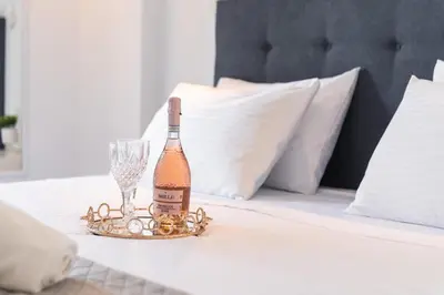 a bottle of champagne and a wine glass on a table at Sweet Dream Premium Apartment in Rhodes Town