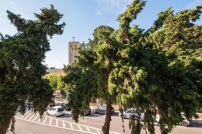 a view of a parking lot with trees and a tower at Sweet Dream Premium Apartment in Rhodes Town
