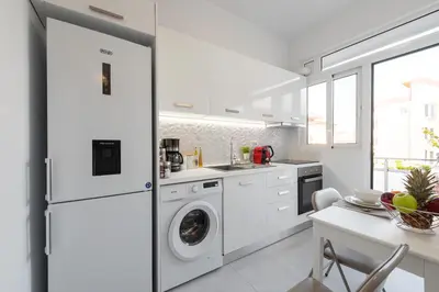 a white kitchen with a washer and dryer at Sweet Dream Premium Apartment in Rhodes Town