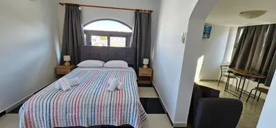 a bedroom with a bed with two teddy bears on it at Primordial Apartment in Rhodes Town