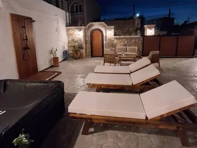 a patio with a bunch of tables and chairs at La casa di Fina in Archangelos