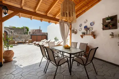 a patio with a table and chairs on a patio at La casa di Fina in Archangelos