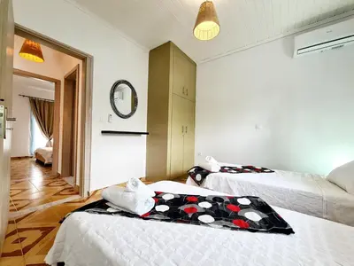a hotel room with two beds and a mirror at Cactus Living in Ialyssos