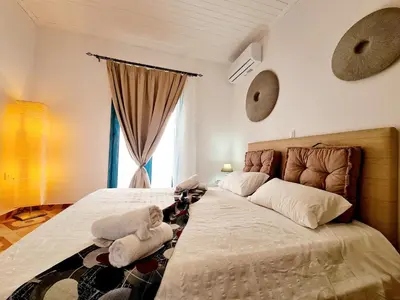 a bedroom with two beds with stuffed animals on them at Cactus Living in Ialyssos