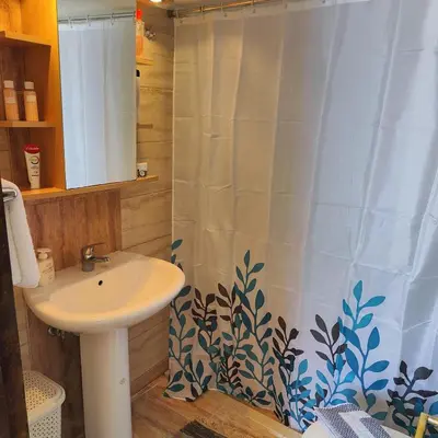 a bathroom with a sink and a shower curtain at Casa di Rena Private House with Sunset View in Kritinía