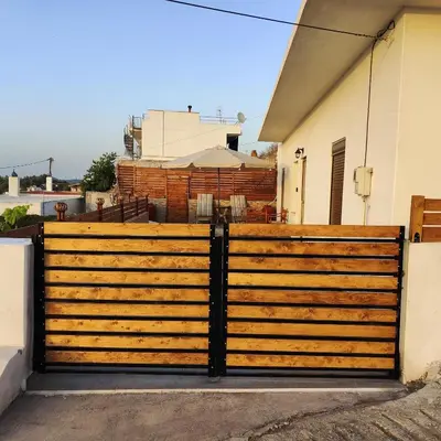 a wooden gate in front of a house at Casa di Rena Private House with Sunset View in Kritinía