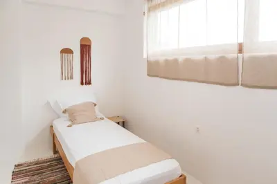 a bedroom with two beds and a window at Maria's Traditional Villa in Asklipiḯon