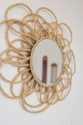 a round mirror on a wall with a wreath at Maria's Traditional Villa in Asklipiḯon