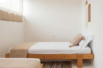 a bedroom with a bed with a teddy bear on it at Maria's Traditional Villa in Asklipiḯon