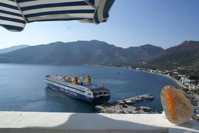 a cruise ship docked at a dock in the water at Annas Studios in Livadia