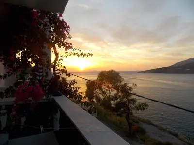 a view of the ocean at sunset from a house at Annas Studios in Livadia
