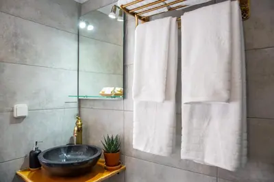 a bathroom with a sink and a shower at Stone Arch in Malona Village