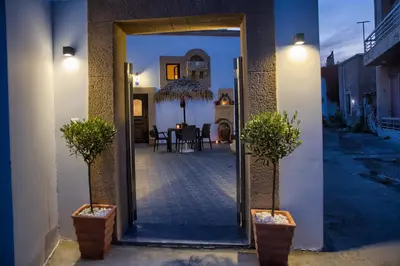 an open door to a patio with a table and chairs at Stone Arch in Malona Village