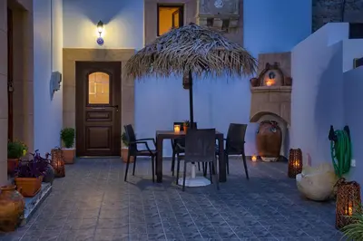 a dining room with a table and chairs and a fireplace at Stone Arch in Malona Village