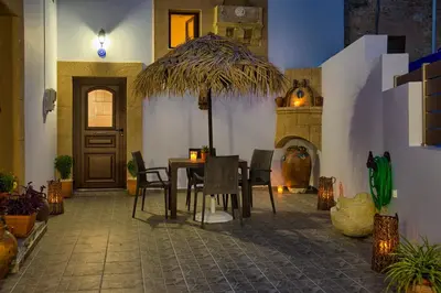 a dining room with a table and chairs in a house at Stone Arch in Malona Village